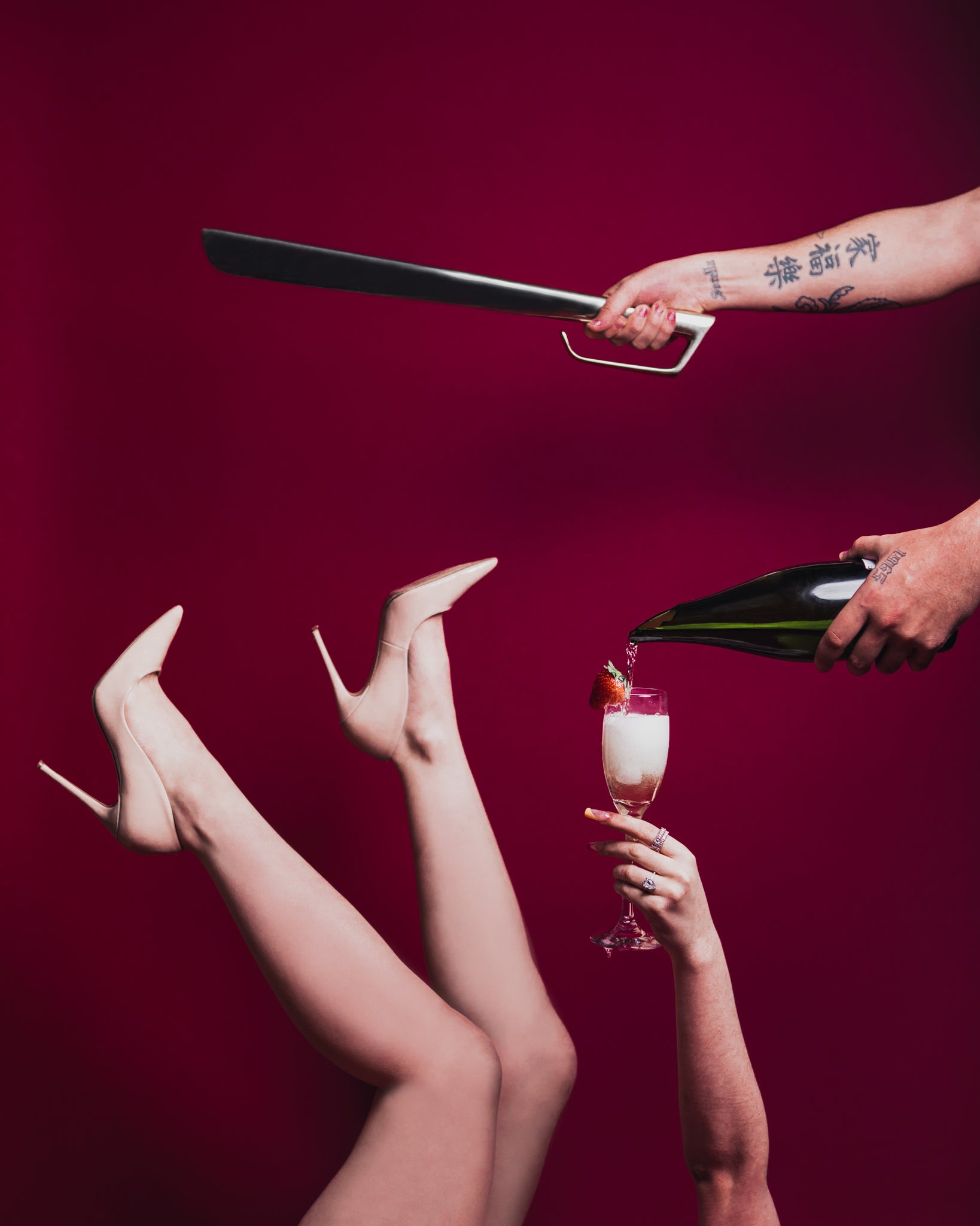 Champagne poured into glass with legs, high heels and strawberry